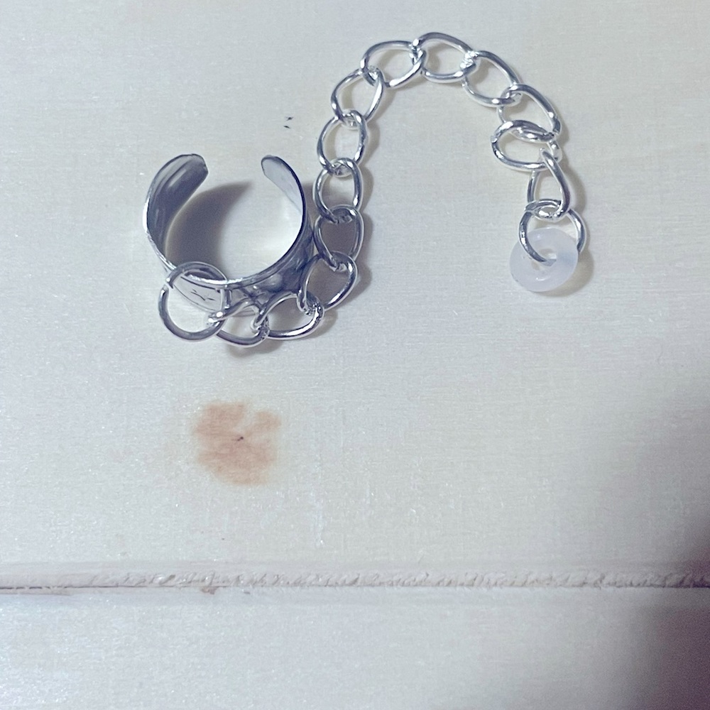 Silver ear cuff earbud holder